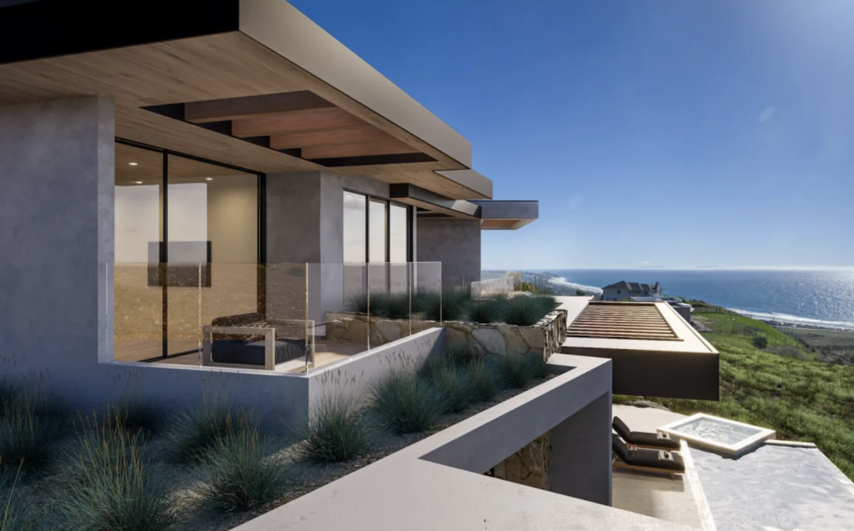 Trancas Malibu's Catalina property - a view of the pool and ocean from the side of the house. Concrete architecture.